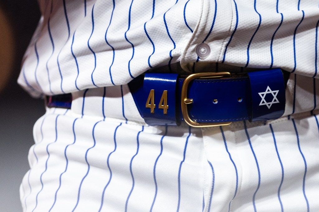 A closeup shot of Bader's dark blue belt with gold buckle, gold number 44 and the Star of David in white