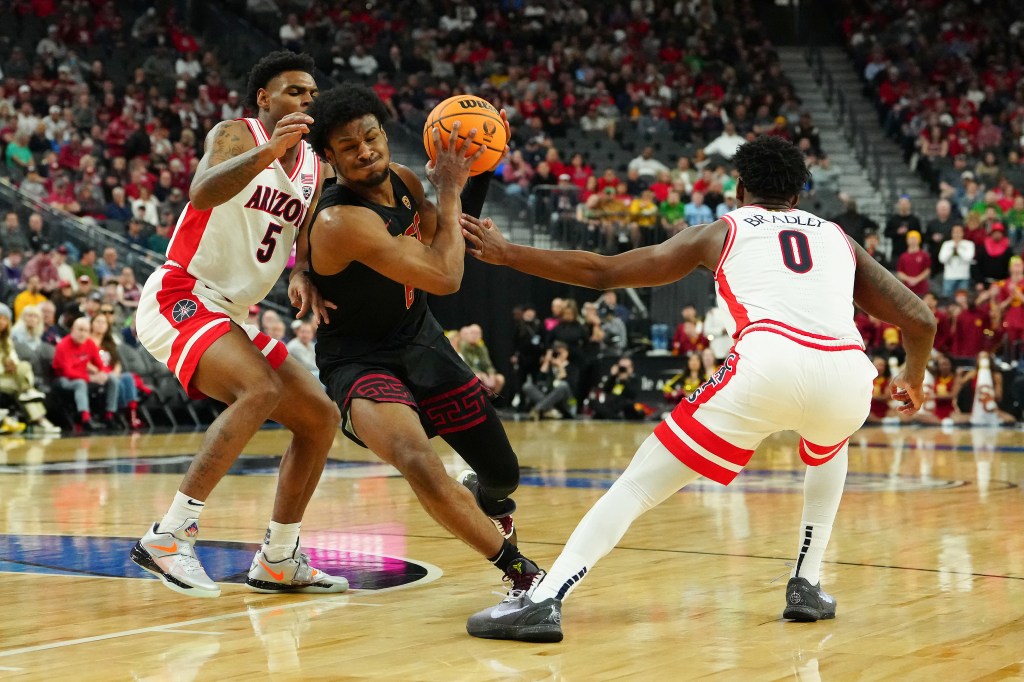 Southern California Trojans guard Bronny James driving the basketball lane amidst Arizona Wildcats guards during a Pac-12 Conference tournament game