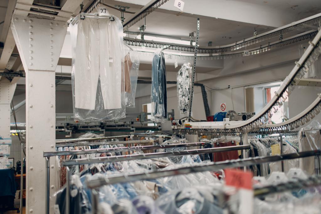 Dry cleaned clothes hanging on a rack after industrial cleaning process