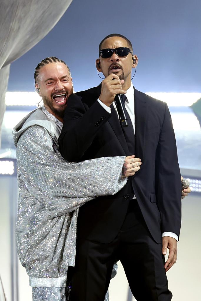 J Balvin hugging Will Smith. 