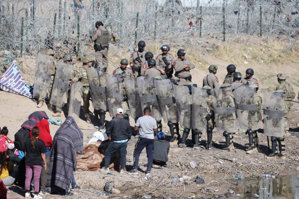 Texas National Guard and state troops face off with migrants