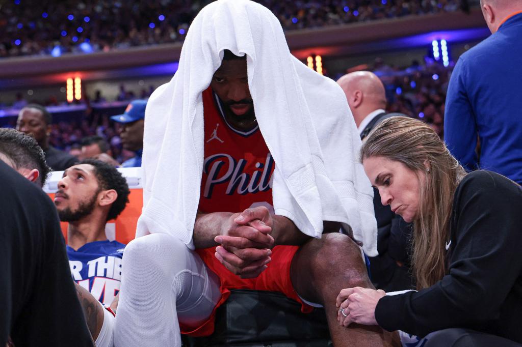 Philadelphia 76ers center Joel Embiid (21) is looked at by medical staff during the second half during game two of the first round for the 2024 NBA playoffs against the New York Knicks at Madison Square Garden. 