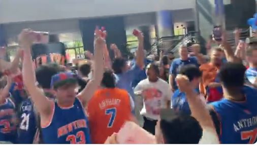 Knicks fans celebrate inside Wells Fargo Center on Sunday.