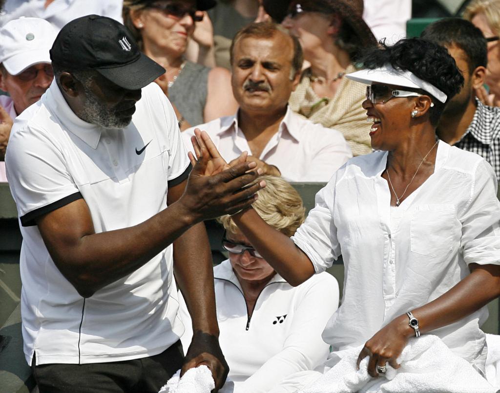 Richard Williams, (L) father of Serena Williams of the US, celebrates with partner Lakeisha Graham after Serena beat Russia's Elena Dementieva 6-7, 7-6, 8-6 during a Women's Semi-Final match in the 2009 Wimbledon Tennis Championships at the All England Tennis Club, in southwest London, on July 2, 2009