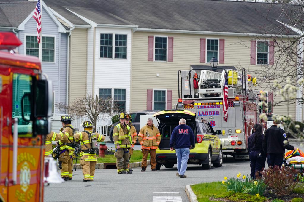 Firefighrers gather outside a home in Lebanon, New Jersey