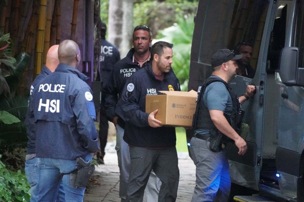Federal agents carrying boxes of evidence from Diddy's Miami mansion