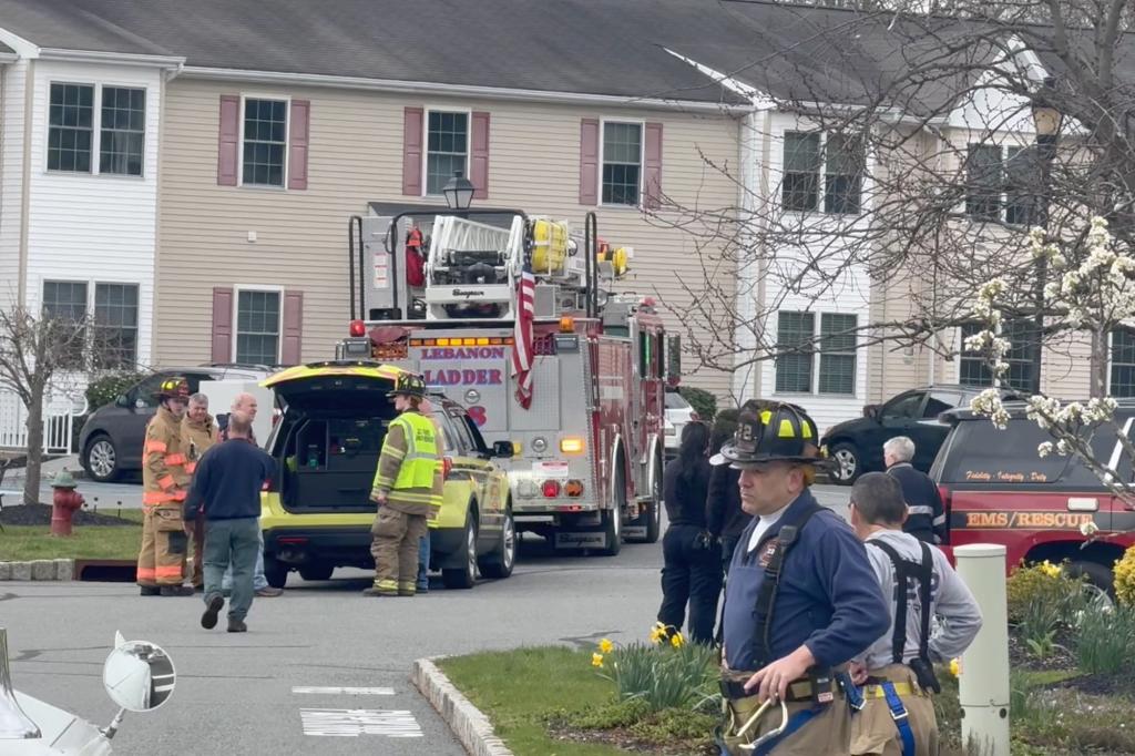 Firefighters and residents gather in the streets in Lebanon, NJ, after the earthquake.