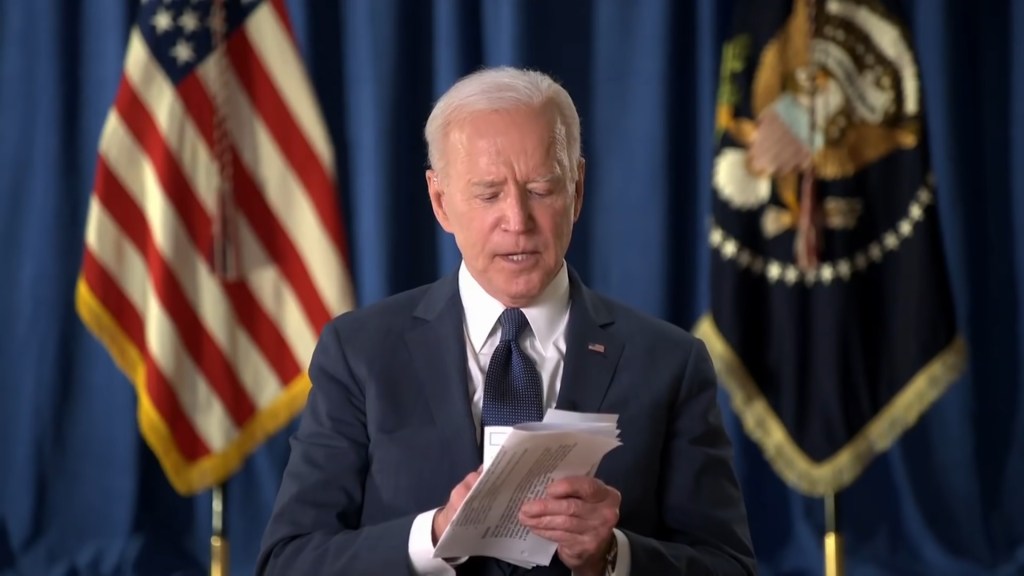 Former ESPN host Sage Steele interviewing President Joe Biden, who is pictured reading a paper during his 2021 appearance on the network