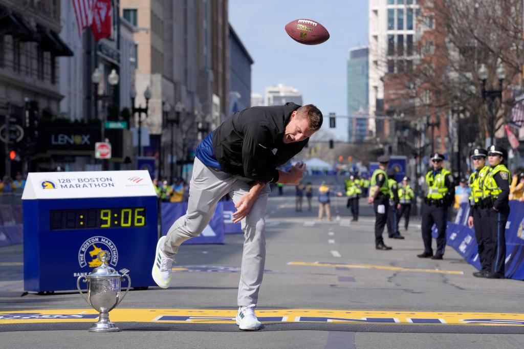 Rob Gronkowski spikes a football on the finish line at the Boston Marathon, Monday, April 15, 2024, in Boston. Gronkowski is grand marshal of the race.  