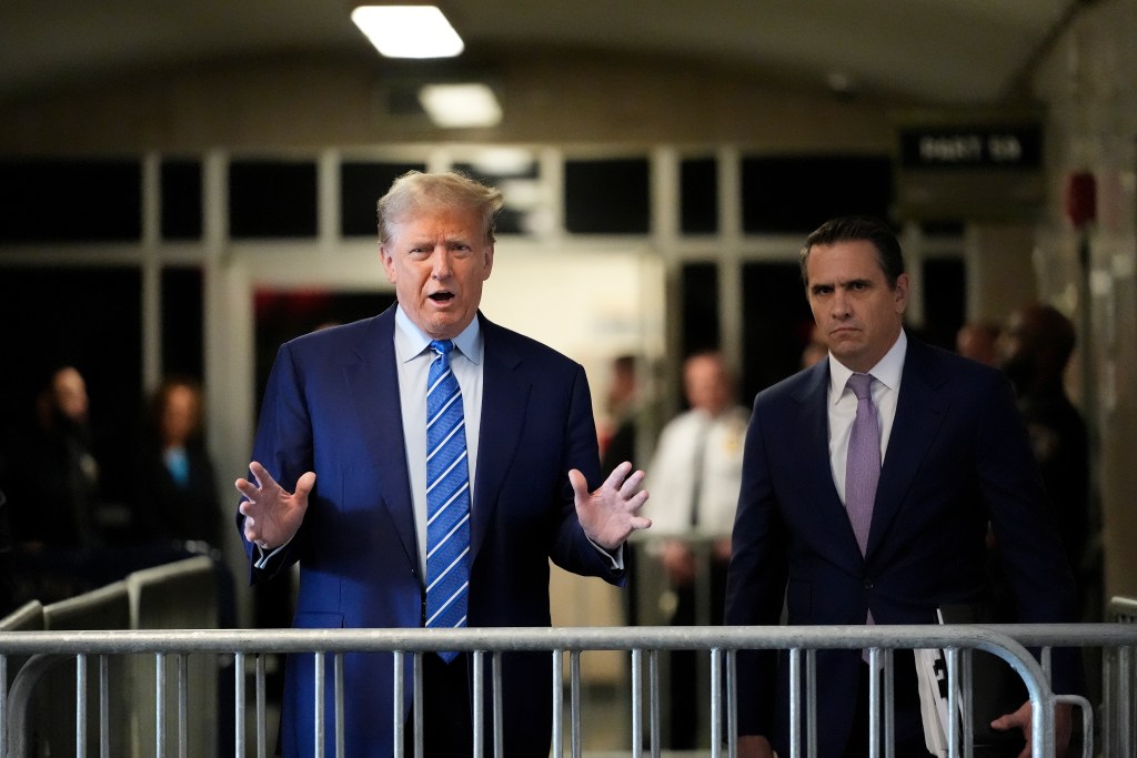 Trump speaks to the media with attorney Todd Blanche as he arrives for jury selection on the second day of his trial for allegedly covering up hush money payments at Manhattan Criminal Court on April 16, 2024 in New York City.