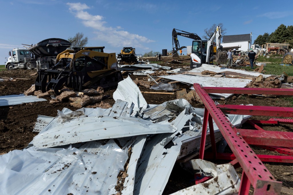 Friends, family and coworkers help clean up the damage on Jared and Tory Crozier's property near Minden,