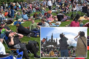 Thousands gathered at Brooklyn's Green-Wood Cemetery on Monday for a solar eclipse viewing party as they watched the sun disappear from the sky above while the dead slumbered below.