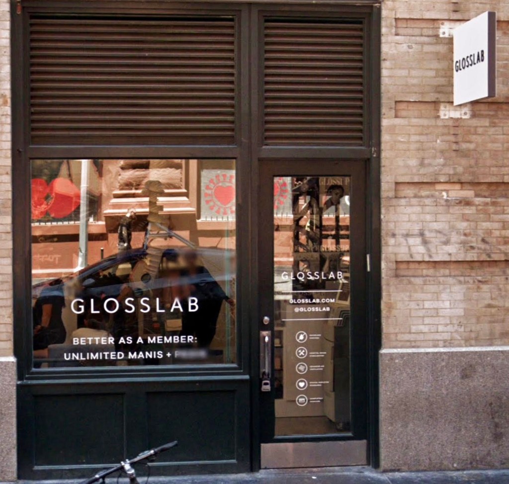 Storefront of GLOSSLAB nail salon in Manhattan with a sign on the front