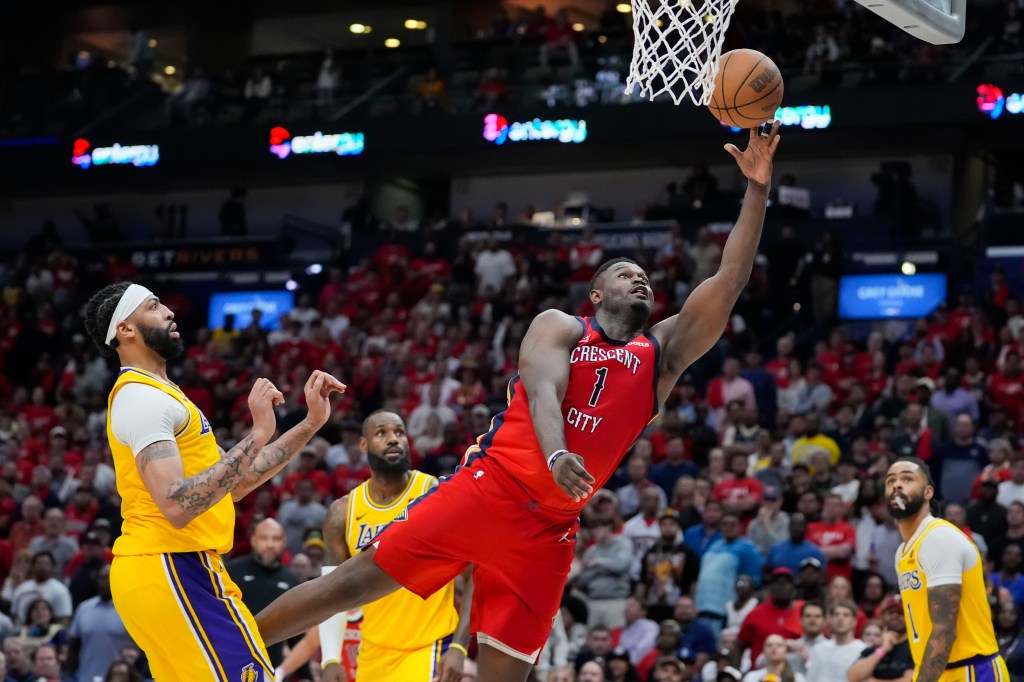 Pelicans forward Zion Williamson (1) goes to the basket ahead of Los Angeles Lakers forward Anthony Davis.