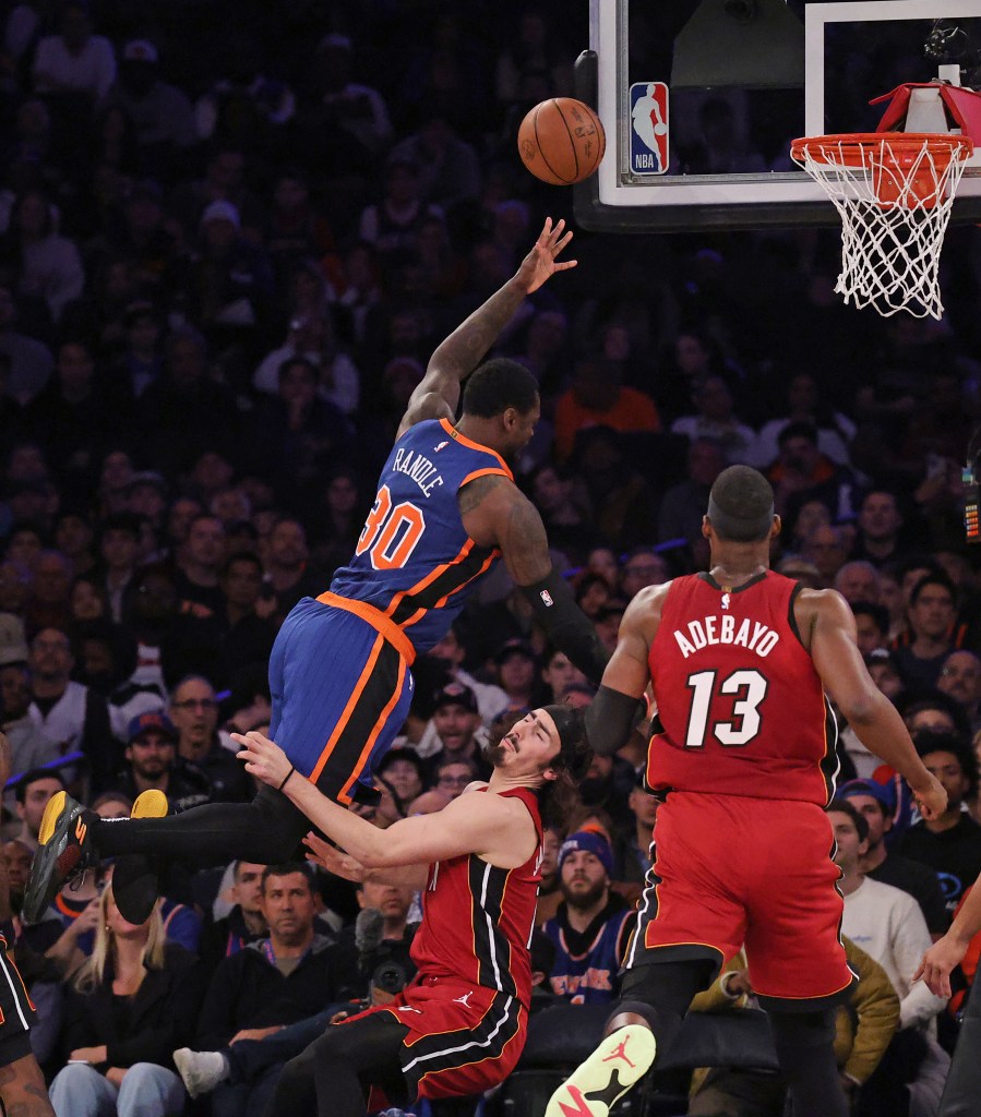 New York Knicks forward Julius Randle (30) goes up for a shot and falls over Miami Heat guard Jaime Jaquez Jr. (11) during a game on January 27, 2024 at Madison Square Garden in Manhattan, NY. 