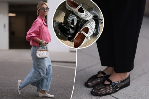 Guest at New York Fashion Week in September 2023, showcasing shoe detail, white maxi dress, silver necklace, handbag and studded Alaia ballet flats