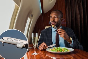 Handsome African American man eating salad in a private jet