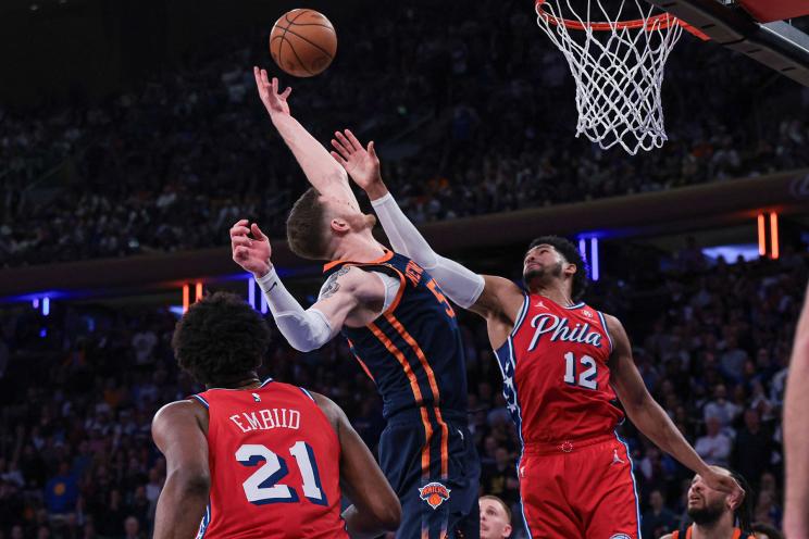 New York Knicks center Isaiah Hartenstein (55) rebounds against Philadelphia 76ers forward Tobias Harris (12) and center Joel Embiid (21) during the fourth quarter during game two of the first round for the 2024 NBA playoffs at Madison Square Garden.