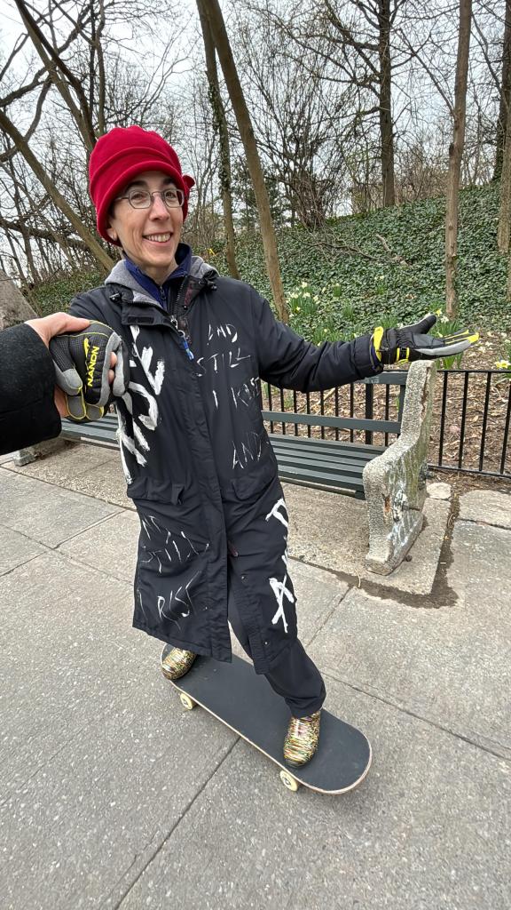 Hayley Gorenberg learning to skateboard after a recent community meeting.