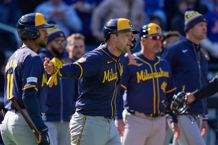 Milwaukee Brewers' Rhys Hoskins yells toward New York Mets' Jeff McNeil as benches cleared during the eighth inning of a baseball game Friday, March 29, 2024, in New York.