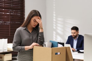 Megan Montaner packing her personal belongings into a box in an office setting