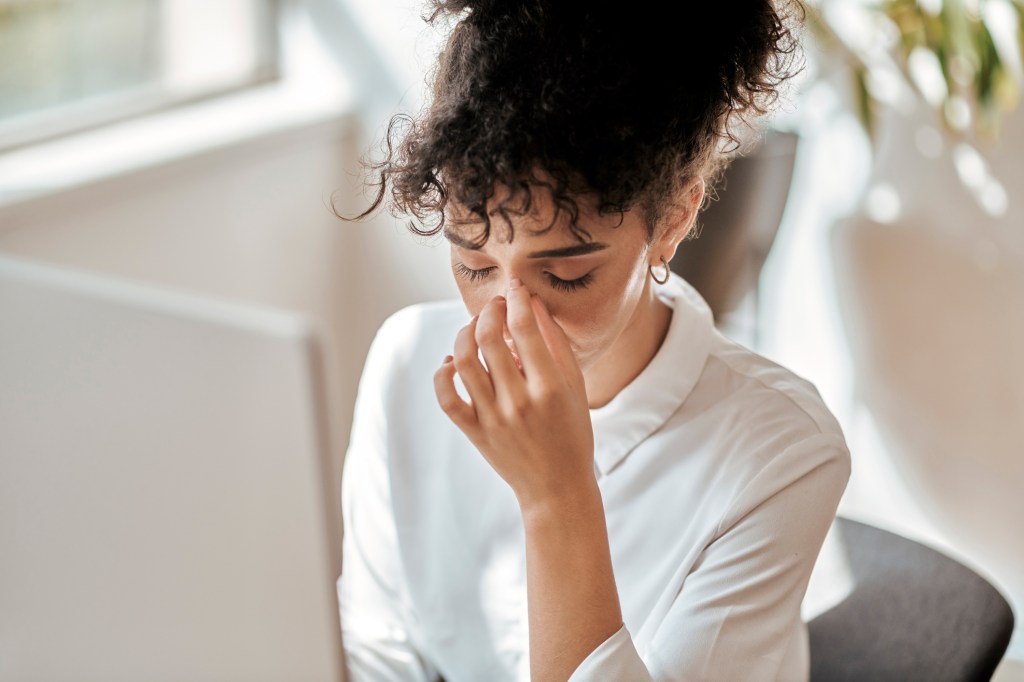 Burnout, stress and business woman in office feeling pain, exhausted or migraine. 