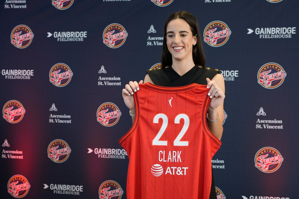 Caitlin Clark posing with her No. 22 Indiana Fever jersey  on April 17, 2024.