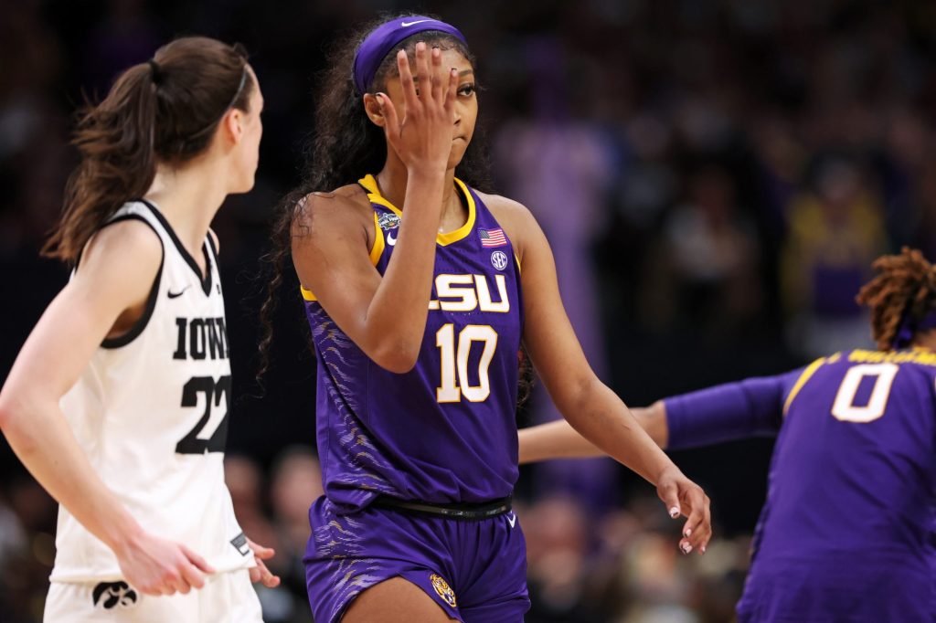 Angel Reese #10 of the LSU Lady Tigers reacts towards Caitlin Clark #22 of the Iowa Hawkeyes.