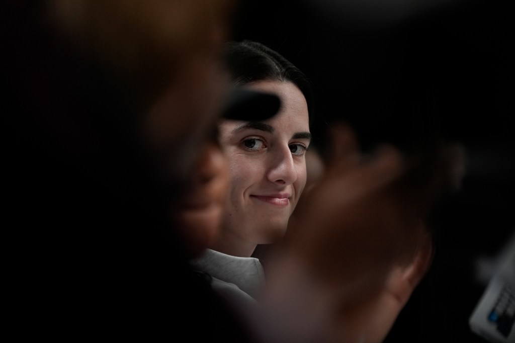 Iowa's Caitlin Clark looks on during a news conference announcing the AP NCAA Women's Coach and Player of the Year