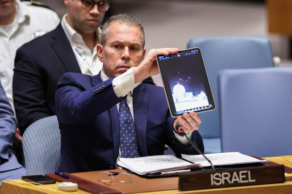 Israeli Ambassador to the UN Gilad Erdan shows a video during a United Nations meeting.