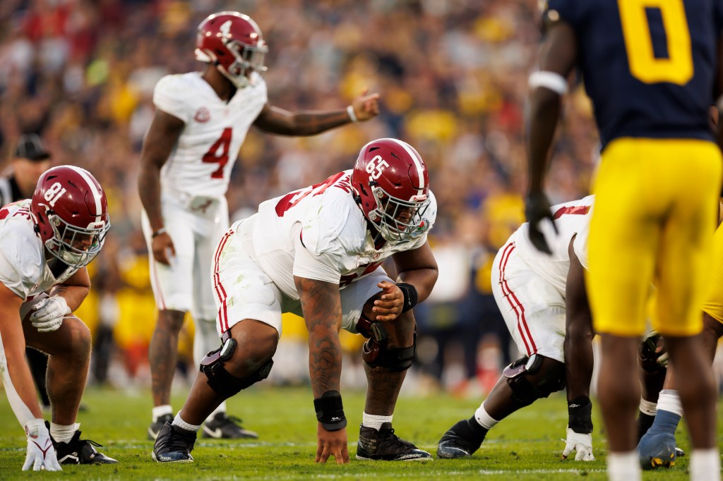 Offensive lineman JC Latham #65 of the Alabama Crimson Tide gets set to block during the CFP Semifinal Rose Bowl Game against the Michigan Wolverines at Rose Bowl Stadium on January 1, 2024 in Pasadena, California.