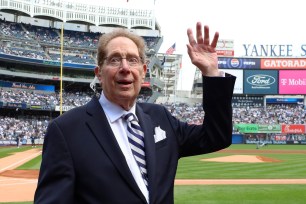 John Sterling waves to the crowd while he is honored by the Yankees in a pre-game ceremony as he retires