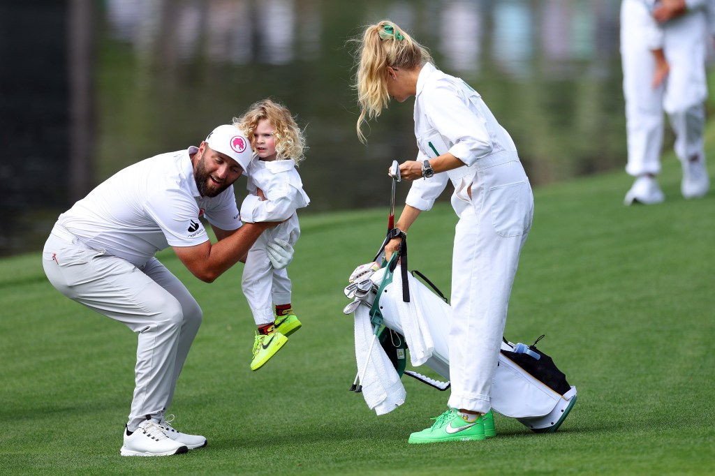 Jon Rahm of Spain holds his son, Kepa, during the Par Three Contest prior