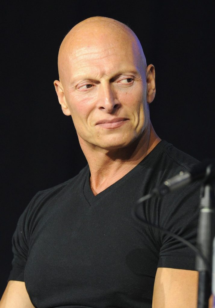 Joseph Gatt speaking on a panel for 'Titanic 666' at WonderCon 2022 in a black shirt