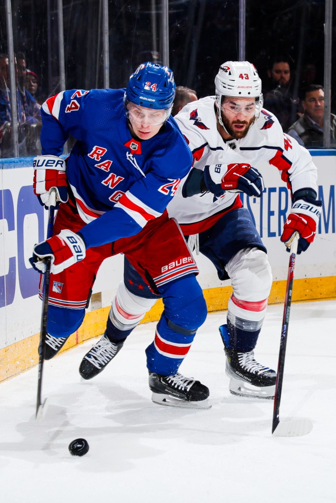 Kaapo Kakko #24 of the New York Rangers fights for the puck against Tom Wilson #43 of the Washington Capitals in Game Two of the First Round