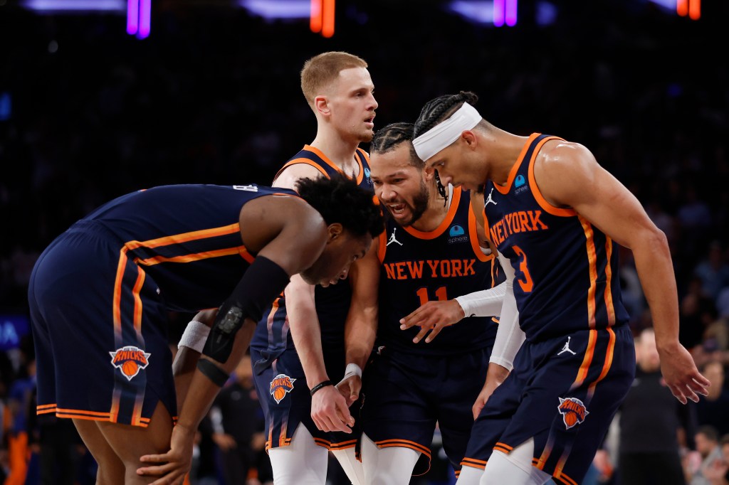 Jalen Brunson #11 of the New York Knicks huddles with Josh Hart #3, Donte DiVincenzo #0, and OG Anunoby #8 of the New York Knicks during the second half against the Philadelphia 76ers in Game Two of the Eastern Conference First Round Playoffs at Madison Square Garden on April 22, 2024 in New York City. 