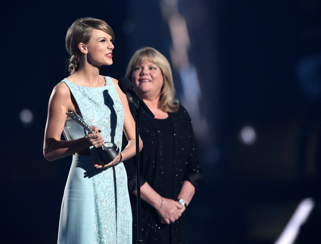 Taylor Swift accepts the Milestone Award from Andrea Swift at the 50th Academy Of Country Music Awards.