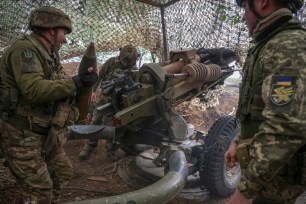 Ukraine service members firing a howitzer towards Russian troops in the Donetsk region on April 21, 2024.