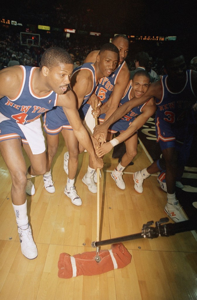 New York Knicks players sweep the floor of the Spectrum in Philadelphia, May 2, 1989 after doing the same to the Philadelphia 76ers in the first round of their Easter Conference Playoff matchup