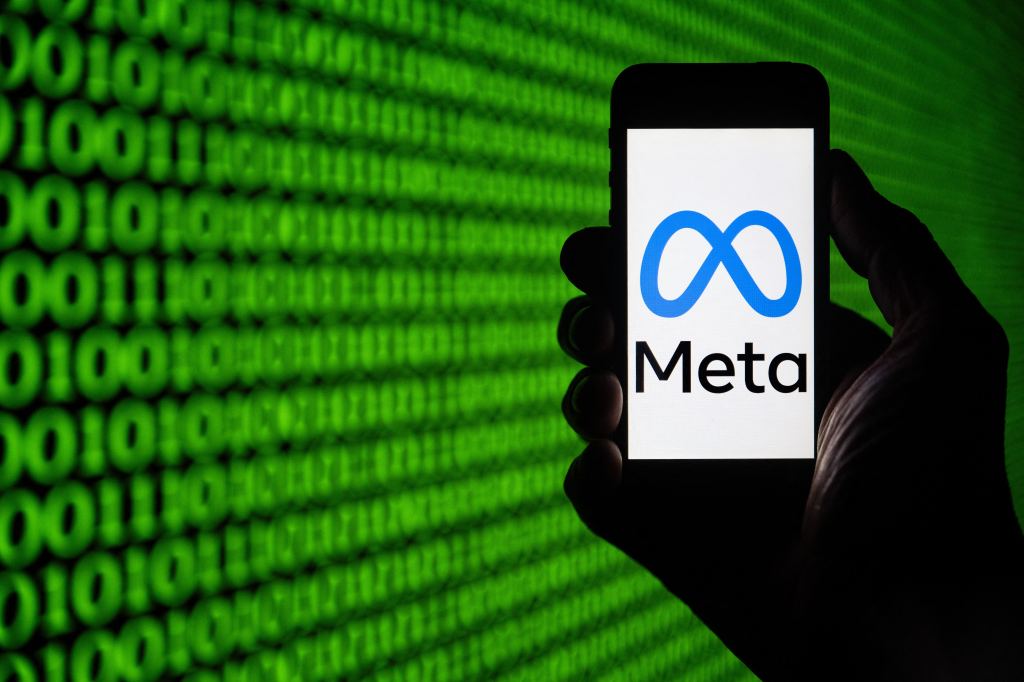 Meta logo displayed on a smartphone screen held in a hand, in Mulhouse, eastern France.