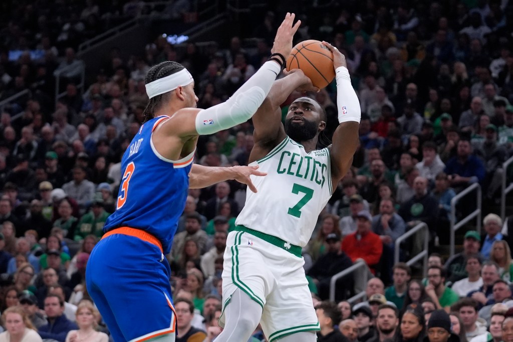 Boston Celtics guard Jaylen Brown (7) looks to shoot at the basket as New York Knicks guard Josh Hart (3) defends in the first half of an NBA basketball game, Thursday, April 11, 2024, in Boston.  