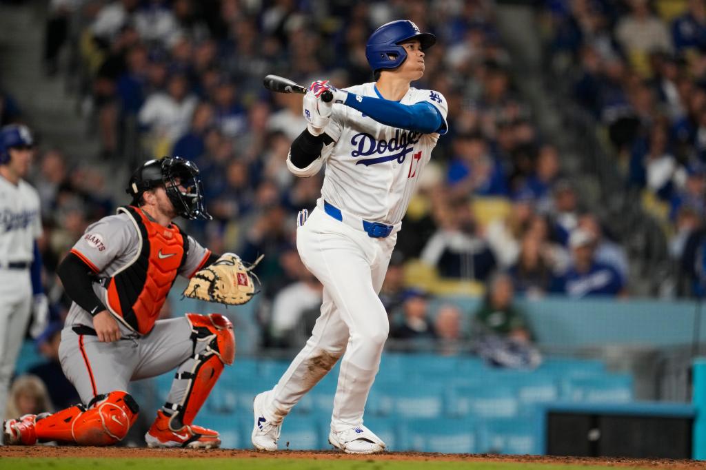 Los Angeles Dodgers batter, Shohei Ohtani, hitting his first home run during a baseball game against the San Francisco Giants