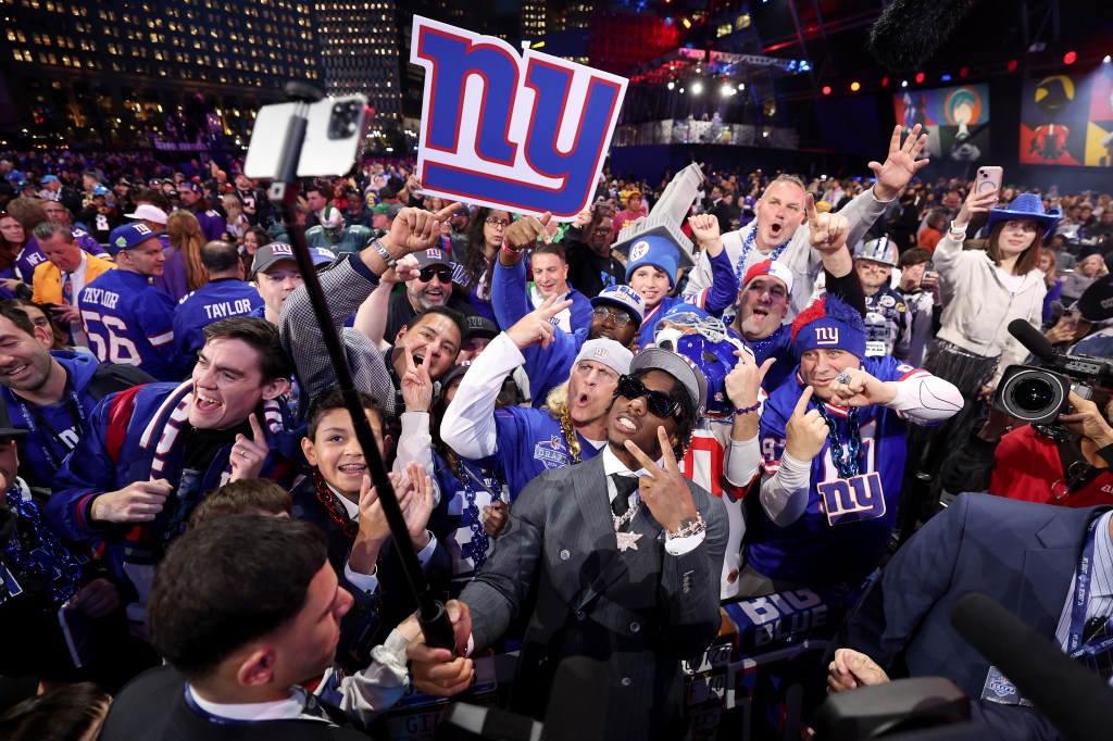 Malik Nabers celebrating with fans after being selected sixth overall by the New York Giants in the 2024 NFL Draft at Campus Martius Park, Detroit, Michigan