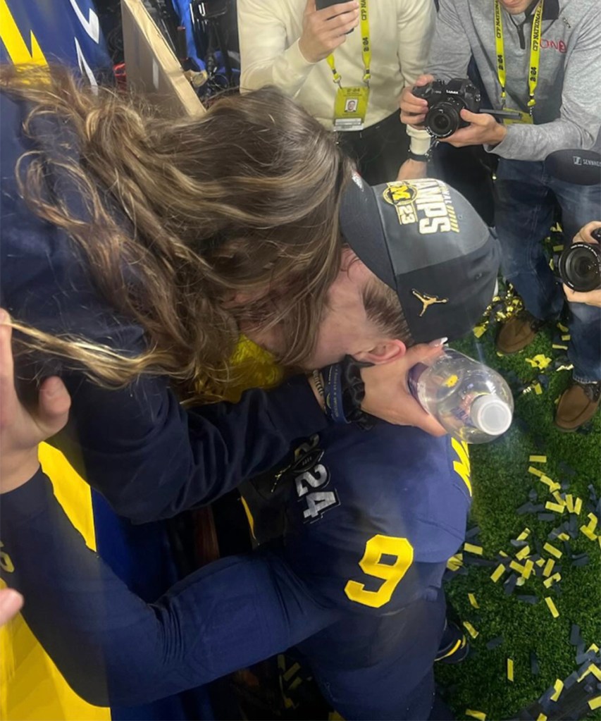 J.J. McCarthy and Katya Kuropas share a kiss after Michigan won the title. 