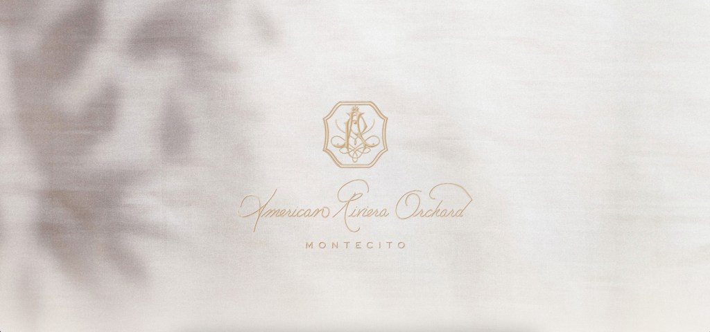 Meghan Markle unveiling her new lifestyle brand, American Riviera Orchard, displayed on a white cloth with gold text