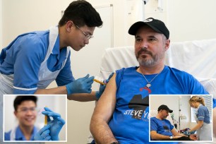 Nurse Christian Medina administers patient Steve Young with his first jab