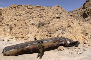 Israeli military personnel inspecting part of an Iranian ballistic missile from the attack on Israel in Arad on April 24, 2024.