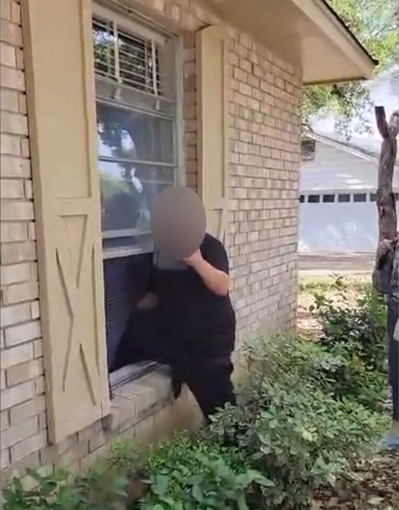 grab from video of man crawling into the window