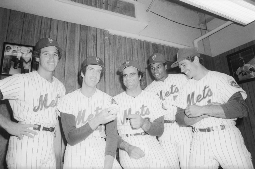 Mets' manager Joe Torre is flanked by newest members of the team, acquired in the "Midnight Massacre" trades that sent Tom Seaver to Cincinnati Reds and Dave Kingman to San Diego Padres. From left to right: Doug Flynn, Pat Zachry, Torre, Steve Henderson, and Bobby Valentine