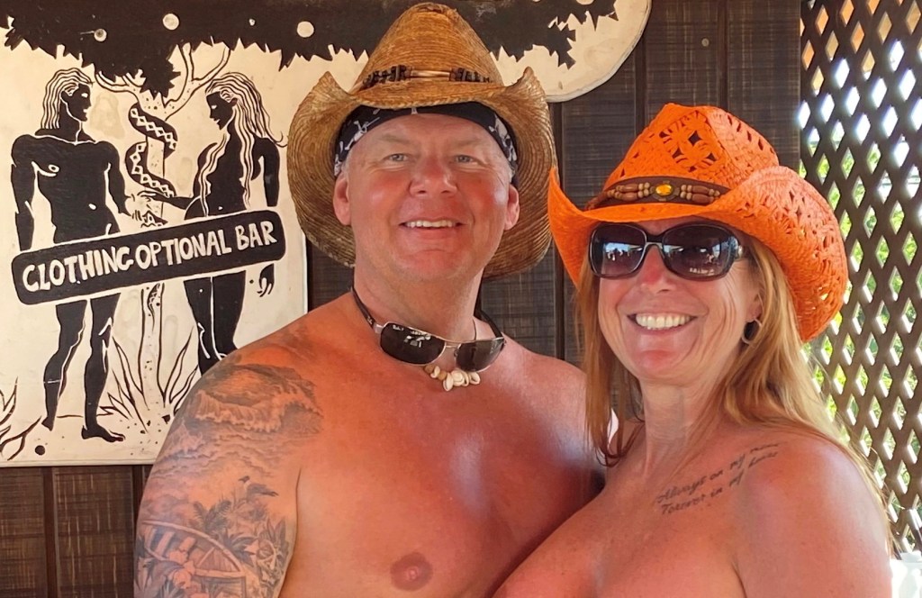 Michael and Laurie Brown, a naturist couple wearing cowboy hats, embarking on their annual nude cruise